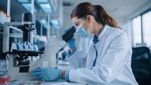 Female Scientist using a Microscope